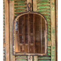 an old wooden door with a mirror on it