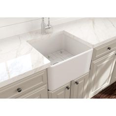 a white kitchen sink sitting under a faucet in front of a marble counter top