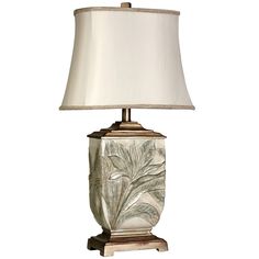 a table lamp with a white shade on it's base and a gold leaf design