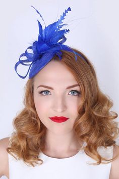 "\"Arianna\" Royal Blue Fascinator This season, sophisticated fascinators stole the show on the runways. Fascinators can be a little intimidating. But this cute little fascinator will help you overcome that fear. It perfectly lands the look, thanks to its mesh sinamay, frilly feathers, and loopy mesh ribbons. No matter the occasion, you will fit in with the fascinator craze with this simple yet stylish head-piece. Add Men's Matching Bow Tie: Don't you dare get caught mismatching your sweetie's f Royal Blue Fascinator, Fascinator Hats Diy, Blue Fascinator, Head Pieces, Dance Mom, Diy Hat, Mesh Ribbon, Head Piece, Fascinator Hats