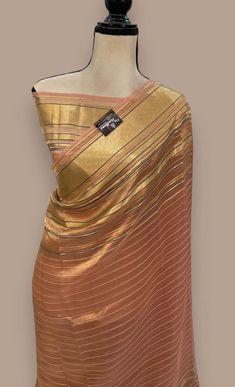 1.this is beautiful pure  tissue chiniya silk sari with resham strips with running blouse piece 2.this sari is 5.5 mt length  3.this is z very elegant looking sari for all occasions like weddings and other formal events  4.fall n pico is complimentary  5.blouse can be made as per the requirements of the clients with proper measurements.stiching charges will be extra  6.plz check the availability of the sari before placing the order Unstitched Gold Silk Pre-draped Saree, Silk Pashmina Shawl With Cutdana, Elegant Silk Pashmina Shawl With Cutdana, Gold Silk Unstitched Suit In Traditional Drape, Unstitched Silk Pre-draped Saree For Puja, Festivals Raw Silk Scarf Saree, Transitional Silk Saree With Unstitched Blouse, Transitional Silk Saree With Blouse Material, Elegant Silk Handloom Blouse Piece