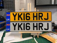 a yellow and black plate sitting on top of a table next to some paper cutters