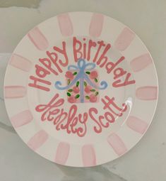 a pink and white plate with the words happy birthday on it