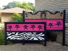 two painted furniture sitting next to each other in front of a brick wall and grass