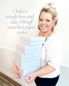 a woman holding a stack of blue boxes with the words order a sample box and take $ 50 off your first paper order