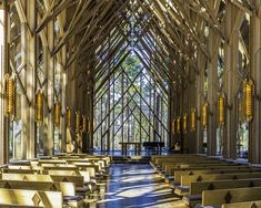 the inside of a church with wooden pews