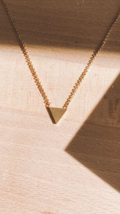 Get to the point and make a statement with this little gold triangle necklace. This statement necklace is a beautiful addition to any look. Triangle Necklace With Adjustable Chain For Gift, Elegant Gold Triangle Necklace, Minimalist Triangle Gold Jewelry, Minimalist Gold Triangle Jewelry, Elegant Triangle Necklace For Gifts, Elegant Triangle Everyday Jewelry, Trendy Triangle Gold Jewelry, Trendy Triangular Gold Jewelry, Trendy Triangle-shaped Gold Jewelry