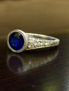 DeKara Designs Collection An Art Deco Platinum Ceylon Blue Sapphire breathtaking ring that must be seen in person to be appreciated.  Metal- 90% Platinum, 10% Iridium.Stones- 1 Round Ceylon Blue Sapphire, 1.83 Carats.  10 Round Diamonds, G color VS1 clarity, 0.36 Carats.  The craftsmanship on this ring is impeccable, and will look extraordinary on a true art lovers finger.  You will wear this ring with great joy, and love.  You will keep glancing at it because it will distract you so much!  Plea Exquisite Diamond Cut Sapphire Ring, Exquisite Diamond-cut Sapphire Ring, Exquisite Sapphire Rings With Brilliant Cut, Classic Sapphire Jewelry Gia Certified, Classic Gia Certified Sapphire Jewelry, Classic Gia Certified Sapphire Ring, Brilliant Cut Round Sapphire Wedding Ring, Sapphire Ring With Diamond Cut, Exquisite Sapphire Ring