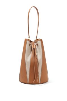 The Large ‘Drum’ bag is shaped in Spain from neutral canvas with harlequin-inspired paneling made from tan leather. It features a drawstring top closure and is hallmarked with an Altuzarra stamped logo. Drawstring Top, Leather Bucket Bag, Brand Collection, Knitwear Tops, Handbag Shoes, Favorite Dress, Canvas Leather, Large Bags, Tan Leather