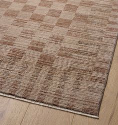 a brown and beige area rug on the floor