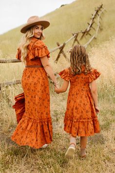 Add a pop of fun to your little's wardrobe with our Mini Shae Dress in Burnt Orange. This playful girl's dress features a unique orange and brown floral print, a high neckline with girly ruffle detailing, and short flutter sleeves. With its midi-length skirt, pockets, and hidden back zipper, this fully lined 100% cotton dress is both stylish and functional. *Please note: some sizes are marked "slightly imperfect" as the lining is slightly longer than the hem of the dress. The sizes marked are fi Cowgirl Dresses, White Bridal Dresses, Brown Floral Print, Skirt Pockets, Aesthetic Dress, Burnt Orange Dress, City Woman, Ankle Length Skirt, White Dress Party