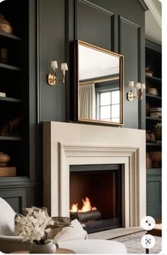 a living room with a fire place and bookshelves on the wall next to it