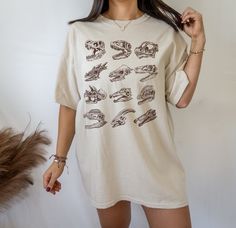 This Dinosaur Skeleton Tshirt is a perfect dinosaur gift for dinosaur lovers likes tyrannosaurus rex T-Rex, Parasaurolophus, velociraptor and more. Perfect to wear at fossil hunting, museums trips or a dinosaur theme birthday parties. For other dinosaur items, click here: https://www.etsy.com/shop/TheNims?search_query=dinosaur Browse through my other awesome items here: http://thenims.etsy.com/ UNISEX TEES Gildan 5000™ (CUSTOMER FAVORITE) * 100% Cotton (fiber content may vary for different color Skeleton Tshirt, Dinosaur Outfit, Dino Shirt, Fossil Hunting, Gift Aesthetic, Dinosaur Skeleton, Dinosaur Shirt, Dinosaur Gifts, Skeleton Shirt