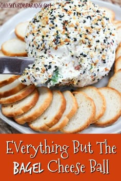 everything but the bagel cheese ball on a platter with crackers and bread