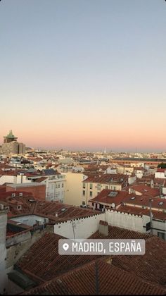 an aerial view of the rooftops and buildings in madrid, spain at sunset or dawn