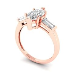 a rose gold engagement ring with three baguets