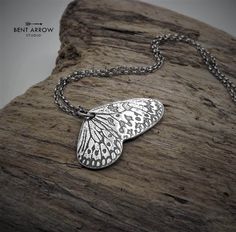 "\"YOUR WINGS WILL CARRY YOU ABOVE THE CLOUDS AND AGAINST THE WIND, FOR YOU ARE STRONGER THAN YOU KNOW.\" Sterling silver hand-forged butterfly wing necklace. This beautifully detailed butterfly wing pendant has been intricately patterned and hand-sawn from solid silver; an homage to the pretty butterflies that give life to summer gardens and meadows around the world. The pendant measures approximately 1 3/8″ wide, and hangs from a sterling silver chain in your chosen length. The piece has been Summer Gardens, Detailed Butterfly, Pretty Butterflies, Raven Pendant, Raven Necklace, You Are Stronger, Necklace Butterfly, Wing Necklace, Butterfly Wing