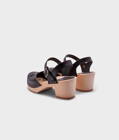 Experience the perfect balance of vintage and modern with our Copenhagen clog sandals. Crafted from natural materials, these stylish sandals embody everything we cherish about fashion from bygone eras while embracing the contemporary spirit of today. Clog measurements:Heel height: 2 5/8” (6.5 cm)Toe height: 1 1/2” (3.8 cm) Fit:NarrowLeather:Vegetable tanned leatherClogs consist of:Base: European lime wood Sole: Rubber sole Fastening: StaplesOther: Metallic Buckle Closed Toe Mary Jane Sandals With Rubber Sole, Chic Closed Toe Sandals With Wooden Heel, Closed Toe T-strap Sandals With Wooden Heel, Chic Closed Toe Slingback Sandals With Wooden Heel, Chic Clogs With Wooden Low Heel, Mary Jane Sandals With Leather Sole, Mary Jane Style Low Heel Sandals With Heel Strap, Vintage Closed Toe Sandals With Stacked Heel, Vintage Summer Mules With Wooden Heel