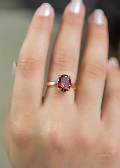 Our Garnet Gemstone Ring features a deep red faceted oval garnet set in a classic four prong setting. This January birthstone ring is Handmade in 925 silver base with a thick coating of nickel free 18k Gold Vermeil. D E T A I L S Stone size - Large - 10mm x 8mm Band size - 2mm Material: 18k thick gold vermeil over 925 sterling silver, genuine red Garnet gemstone Birthstone Month: January S H I P P I N G * Processing time - 2 business days, usually ships the next day. We are closed on Saturdays a Silver Rings With Red Stone, Birthstone Gold Ring, Gold Ring With Ruby Stone, Ruby Gemstone Ring, Gold And Garnet Ring, Oval Garnet Ring, Gold Stone Rings For Women, January Birth Stone Rings, Garnet Silver Ring