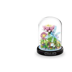 a glass dome with flowers inside on a black base and an inscription underneath it that reads,