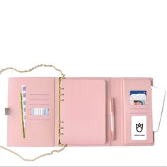 a pink binder with a chain hanging from it's side and a notepad attached to the back