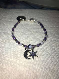 This bracelet is a Moon and Star Bracelet with purple beads, crystals, and silver accents, magnetic clasp with charm. I make all jewlery to order to let the customer customize color, size, and even charms. I appreciate your support! Thank you! Love and Light! If you require any special adjustments please message me. Standard bracelets are 7.5 inches. Purple Adjustable Celestial Jewelry, Adjustable Purple Celestial Jewelry, Handmade Purple Sterling Silver Beaded Bracelets, Spiritual Purple Crystal Bracelet With Spacer Beads, Purple Star-shaped Beaded Jewelry, Spiritual Nickel-free Purple Beaded Bracelets, Spiritual Purple Beaded Charm Bracelet, Afro Jewelry, Grunge Jewelry