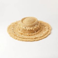 Embrace the sun while keeping cool and stylish with our Chic Raffia Sun Hat. Handcrafted from high-quality raffia, this hat is a must-have accessory for any beach goer or outdoor enthusiast looking to combine fashion with functionality. The elegant shell decoration adds a touch of seaside charm, making it a standout addition to your summer wardrobe. Key Features Sun Protection: Enjoy your day in the sun without the worry, as our hat offers excellent protection against harmful UV rays. Material: Made from 100% natural raffia, known for its durability and breathability. Design: Features a solid pattern with a casual style that complements any outfit. Seasonality: Perfect for spring and summer, providing both comfort and style in warm weather. Product Benefits Versatile Fashion: Its neutral c Short Brim Straw Hat For Sunbathing Vacation, Vacation Straw Hat With Short Brim For Sunbathing, Beige Sun Hat For Sunbathing, Straw Hat For Sunbathing, Beige Beach Hat With Uv Protection, Beige Sun Hat For Summer Beach, Summer Beach Beige Sun Hat, Brimmed Straw Hat For Sunbathing On Vacation, Beachwear Straw Hat For Sunbathing During Beach Season