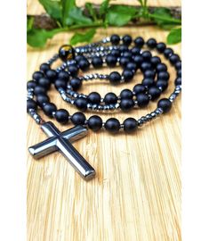 Natural Matte Black Onyx Cross Necklace Pendant. Black Onyx and Hematite Stones Beads. Christian Catholic Christ Rosary. Religious Prayer Beads. Crucifix. Mens Jewelry. Religious gift. Onyx provides us with strength and promotes vigor.  It helps us with steadfastness and stamina and imparts self-confidence. It centers our being and aligns us with our higher power, providing us with focus, dedication, and self-control.  As a grounding stone, it helps stimulates our power to make wise decisions an Black Hematite Spiritual Jewelry, Spiritual Black Cross Beaded Necklace, Spiritual Hematite Necklace With Black Beads, Black Hematite Jewelry With 8mm Beads, Black Hematite Round Bead Jewelry, Black Hematite Bead Jewelry, Black Hematite Round Beads Jewelry, Black Hematite Beaded Necklaces With Round Beads, Black Hematite Beaded Necklaces