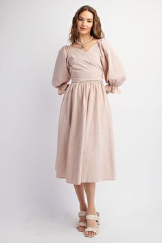 This dress features a sweetheart neckline and bubble sleeves with elasticized cuffs, as well as a smocked waistline and back. The adjustable top allows for multiple looks, and the side pockets add functionality. Its loose and flowy fit offers comfort and style. Length measures at 45.5" with a bust measurement of 14.5". 100% Cotton Summer Peasant Dress With Gathered Sleeves For Brunch, Spring Peasant Dress With Gathered Sleeves, Peasant Dress With Gathered Sleeves For Spring, Relaxed Fit Dresses With Puff And Gathered Sleeves, Billowy Peasant Dress With Gathered Sleeves For Daywear, Summer Smocked Dress With Bishop Sleeves, Spring Midi Dress With Gathered Bishop Sleeves, Spring Midi Dress With Bishop Elastic Sleeves, Spring Peasant Dress With Puff Sleeves