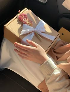 a woman's hand holding onto an open gift box