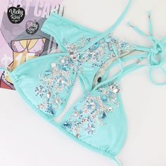 "Oh, what a bright and stylish bikini! This Turquoise Designer Swimwear will be your perfect decoration and complement! The incredible brilliance of the crystals of this bikini will cover the whole audience. Excellent tailoring will give confidence combined with a beautiful bikini stage look. So everyone will be Amazed by the beauty of your Crystal Bikini! ❤ Fully lined ❤ Adjustable drawstring triangle top with push up ❤ Beautiful sparkle appearance ❤ Hand-applied crystals ❤ Spandex material ❤ H Turquoise Halter Neck Swimwear For Swimming, Turquoise Halter Neck Swimwear For Poolside, Triangle Top Swimwear For Beach Party, Triangle Top Swimwear For Beach Season Party, Turquoise Fitted Swimwear For Poolside, Fitted Turquoise Swimwear For Poolside, Party Triangle Top Swimwear For Beach Season, Fitted Turquoise Swimwear For Beachwear, Turquoise Triangle Top Swimwear For Summer