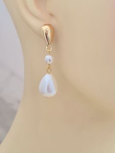 Introducing these gorgeous shell coated pearl drop earrings with gold plated teardrop studs.  Elegant and suitable for your special occasion. These earrings measure just over 1.5in/4.2cm. The earrings will arrive in a bag ready for giving. This item ships from the UK within 1 working day. Pearl Drop Teardrop Dangle Earrings, Formal Dangle Pearl Drop Earrings, Teardrop Pearl Charm Earrings For Anniversary, Pearl Teardrop Dangle Earrings With Pearl Drop, Gold Teardrop Clip-on Earrings For Wedding, White Teardrop Clip-on Earrings, White Teardrop Clip-on Jewelry, Elegant White Pearl Drop Clip-on Earrings, Clip-on Dangle Pearl Earrings