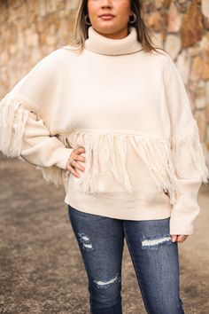 Our "Fringe Turtle Neck Sweater" is a cream colored sweater with a fringe detail and turtle neckline. Our model is wearing a size Small. Chic Fringe Sweater For Fall, Beige Long Sleeve Sweater With Fringe, Fall Beige Fringe Top, Beige Fringe Casual Sweater, Cream Colored Sweater, Turtle Neck Sweater, Turtleneck Sweater, Kids Accessories, Cream Color