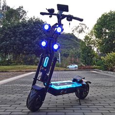 an electric scooter with blue lights on the front and back wheels parked in a parking lot