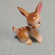 a small ceramic figurine of a baby deer