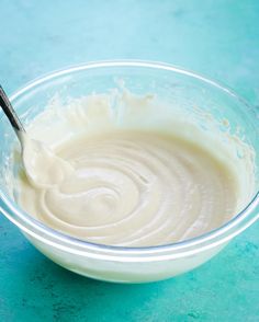 a bowl filled with white liquid on top of a blue table