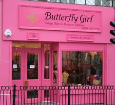 a pink building with the words butterfly threads written on it