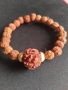 Rudraksha Wrist Bracelet Stretchable with Large Rudraksha Guru Bead Energized A Rudraksha wrist bracelet with a stretchable design and a large Rudraksha guru bead is a popular accessory in spiritual and holistic practices. Here are some key points about such bracelets: Stretchable Design: The stretchable feature makes the bracelet easy to wear and remove, providing comfort and flexibility for different wrist sizes. Large Rudraksha Guru Bead: The guru bead, often larger than the other beads in the bracelet, typically serves as a focal point for meditation and prayer. It's considered significant in many spiritual traditions. Energized: The term "energized" suggests that the bracelet may have undergone a ritual or ceremony to imbue it with spiritual energy or blessings. This is a common pract Spiritual Hand-strung Beaded Bracelets For Rituals, Spiritual Beaded Bracelets For Festivals, Traditional Hand-strung Stretch Bracelet, Adjustable Spiritual Bracelets For Festivals, Spiritual Brown Bracelet For Rituals, Adjustable Beaded Bracelets For Rituals, Spiritual 8mm Beads Bangle Bracelet, Spiritual Beaded Bangle Bracelets With 8mm Beads, Spiritual Beaded Bangle Bracelets For Festivals