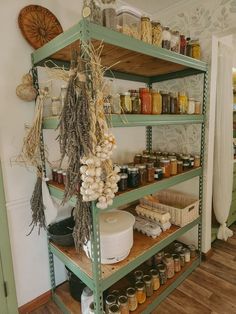 a shelf filled with lots of different types of spices and condiments on top of wooden shelves