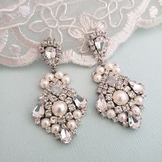 Hollywood Glam crystal earrings, made with top Swarovski rhinestones hand sett on silver filigree drop . finished with hypo allergenic surgical steal ear wire. Original design , hand crafted by me in my studio. Light weigh and very comfortable to wear . Matching necklace at this link: https://www.etsy.com/listing/1069151729/bridal-crystal-necklace-vintage-style?ref=shop_home_active_1&frs=1 Please contact me if you have any questions. Vintage Bridal Earrings, Bridal Shoes Vintage, Vintage Bridal Hair, Crystal Wedding Necklace, Blue Bridal Earrings, White Opal Earrings, Crystal Earrings Wedding, Crystal Bridal Earrings, Earrings Chandelier