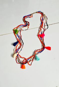 Boho multi color multi layered beaded and tassel long necklace. Multi colored vibrant and colorful tassel necklace has six beaded strands with multiple color tassels. The necklace looks pretty cool and colorful. Ideal for holidays and summer season. Necklace length approx.34 inches. * The products are handmade and shipped from India. * Package preparation time is 1 to 2 business days. * Standard shipping - It will take approx. 2 - 3 weeks. * Express shipping - The transit time is 3-7 days worldwide.  * All kind of taxes, custom duties, VAT etc will be borne by the buyer as I am not responsible for the same. * Please refer to our policies for for refund and returns. * Do contact or send me conversation if you have any questions. Thank you:-) Back to the store - https://www.etsy.com/your/sho Multi Colour Necklace, Necklace Seed Beads, Beads Tassels, Ivory Necklace, Festival Necklace, Multi Necklace, Owl Pendant Necklace, Multi Coloured Necklaces, Bold Necklace