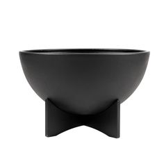 a black bowl sitting on top of a wooden stand