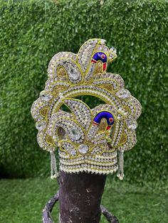 Beautiful Mukut for our Krishna . Pearl and Stone work crown for kanha ji and other deity idols  Two sizes available  1. Ideal for head circumference of 6-8 inch  Weight of crown is approx 110 gms  2. Ideal for head circumference of 5-7 inch . Weight of crown is approx 72 gms  Quality guaranteed  From land of Krishna, Mathura Traditional Gold Headpiece With Tall Crown, Traditional Gold Headpiece With Structured Crown, Traditional Gold Structured Crown Headpiece, White Crown Headpieces As Gift, Royal Tall Crown For Wedding, Traditional Gold Crown Headpiece, Traditional Gold Headpieces For Celebration, Ceremonial Festive Tilla Headpieces, Regal Tall Crown Headpieces For Wedding