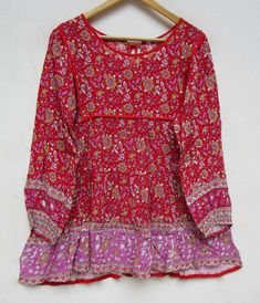 "ITEM DESCRIPTION pink red floral printed rayon bohemian women blouse and tops - boat neckline with back tassel blouse - long sleeve summer blouse and tops Features : Long sleeve, boat neck, Blouse Material : rayon crepe Fabric: 100% rayon soft light weight ethnic print fabrics Sleeve Length = 22 inch For more sizes & their measurement, please refer our below chart to understand the sizes variations available with us For your size requirement, please mention your size in seller note at the t Red Tunic Tops For Spring, Bohemian Long Sleeve Floral Print Top, Red Tunic Blouse For Summer, Bohemian Long Sleeve Peasant Top With Boho Print, Red Long Sleeve Bohemian Blouse, Floral Print Long Sleeve Festival Top, Bohemian Long Sleeve Peasant Top, Red Summer Tunic Top, Red Long Sleeve Blouse For Summer