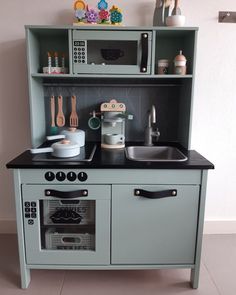 a play kitchen with an oven and sink