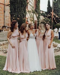 the bridesmaids are all wearing pink dresses and one is holding her hand on her hip