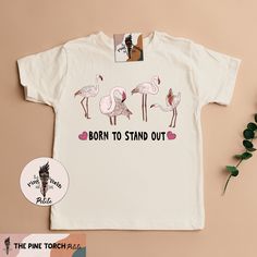 BORN TO STAND OUT: Designed and handmade in Phoenix - ▲Designed and handmade in Phoenix.▲ ▲The "PETITE" kids/baby sister shop of THE PINE TORCH® - our main shop with over 100,000 sales and 25,000 5 star reviews - since 2015! ▲ https://www.etsy.com/shop/ThePineTorch Born to stand out! This amazing flamingo design is perfection. Makes the perfect pregnancy announcement, newborn baby gift, birthday shirt, and beyond! * * * * * * * * * * * * * * * * * * * * * * * * * * * * *  ▲Our main shop, The Pin Pink Flamingo Print Short Sleeve T-shirt, Pink Short Sleeve T-shirt With Flamingo Print, Flamingo Design, Phoenix Design, Flamingo Shirt, Kids Holiday Gifts, Cotton Bodysuit, Baby Sister, Newborn Baby Gifts