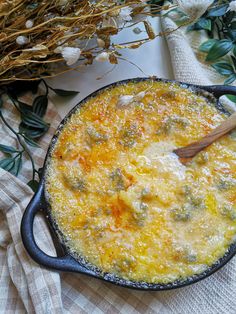 an omelet in a cast iron skillet with a wooden spoon on the side