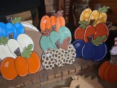 pumpkins and gourds are on display in front of other decorative items for sale