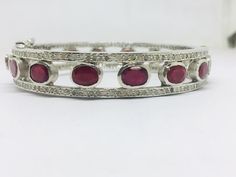 Listing is for (1) one beautiful Solid sterling silver 925 two tone pave diamond ruby bangle (price for one psc.) diamond wt: 2.1 cts. silver wt: 45 gms. stone wt: 8 cts. Gemstone name:- Diamond Ruby It's a beautiful bracelet (bangle). two tone pave diamond ruby bangle perfect for summers. Light weight . perfect for gifting and wedding. We keep on adding new products & designs every day so keep coming back to get more deals & designs. Bulk & wholesale orders are welcome on this desig Diamond Bangle Fine Jewelry Hallmarked, Hallmarked Diamond Bangle Fine Jewelry, Oval Bangle With Diamond Accents In Fine Jewelry Style, Silver Ruby Jewelry With Pave Setting, Round Bangle With Rose Cut Diamonds, Oval Bangle With Single Cut Diamonds, Round Diamond Bangle With Rose Cut Diamonds, Oval Diamond Bangle With Single Cut Diamonds, Silver Bangle With Pave Setting